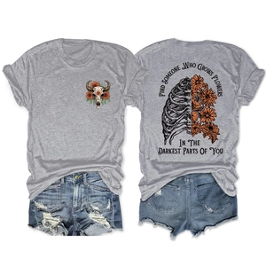 Flat lay view of grey cotton T-shirt with rib cage floral print and denim shorts set