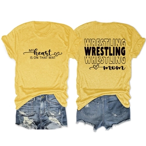 Detailed flat lay of a yellow Wrestling Mom t-shirt and distressed denim shorts