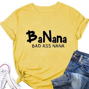 Flat lay of yellow BaNana Bad Ass Nana cotton t-shirt with blue jeans and white shoes