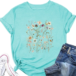 Close-up of elegant wildflower print and knot-tie detail on a turquoise cotton T-shirt
