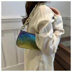 Detailed shot of holographic gradient underarm bag with thick champagne gold chain strap