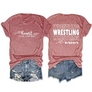 Detail of Wrestling Mom t-shirt print with distressed denim shorts on white background
