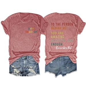Detail view of the front and back of a red heather crew neck T-shirt with inspirational text