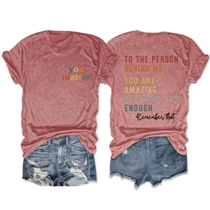 Detail of red heathered t-shirt featuring 'you matter' text and distressed denim shorts