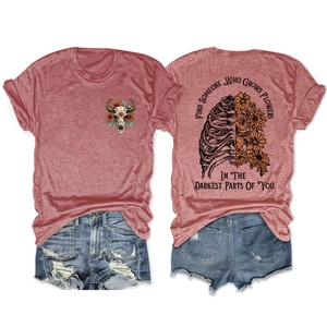 Detail of red t-shirt with sunflower ribcage print and distressed denim shorts