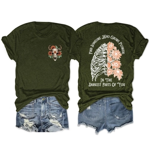 Detail of dark olive t-shirt with floral bull skull print and ripped denim shorts