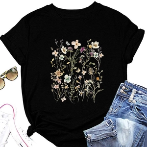 Flat lay of a black floral T-shirt with vintage botanical print and casual styling items