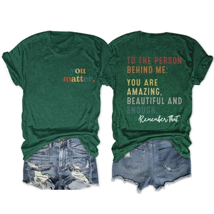 Close-up of dark green t-shirt with You Matter print and distressed denim shorts