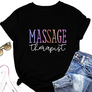 Flat lay of black crew neck T-shirt with MASSAGE therapist print and casual accessories