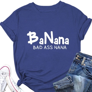 Flat lay of navy blue T-shirt featuring BaNana BAD ASS NANA text with denim and shoes