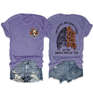 Purple T-shirt detail showing floral rib cage back print and front bull skull graphic