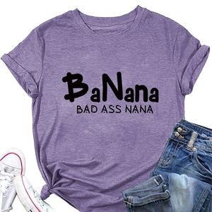 Flat lay of purple cotton T-shirt with black printed slogan and denim shorts outfit