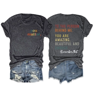Detail view of charcoal t-shirt with back quote print and distressed denim shorts