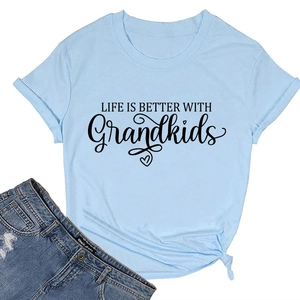Flat lay of light blue T-shirt with 'Life is Better with Grandkids' print and denim shorts