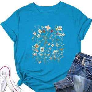 Detail of light blue t-shirt featuring hand-painted colorful wildflowers and rolled sleeves