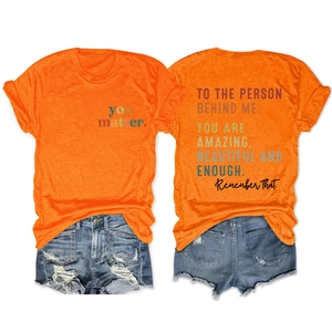 Detailed front and back views of orange T-shirt featuring inspirational back print and quote