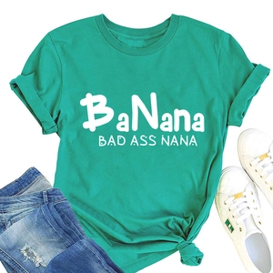 Flat lay of a teal crew neck t-shirt with BaNana print paired with blue ripped jeans