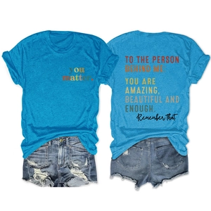 Detailed flat lay of royal blue t-shirt with back inspirational quote and denim shorts