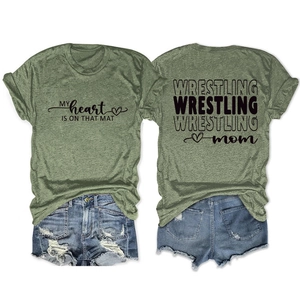 Detail view of Wrestling Mom olive green t-shirt with heart graphic and denim shorts