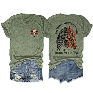 Flat lay of olive green t-shirt showing back graphic with ribcage and orange flowers