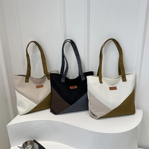 Three large canvas tote bags with geometric color-block designs and long handles