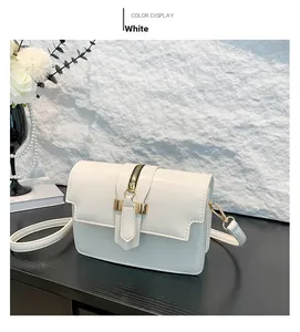 Detailed view of a white faux leather shoulder bag with golden zipper and metal hardware