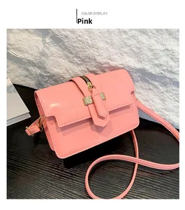 Pink glossy crossbody bag detail showing decorative metal zipper and magnetic square buckle
