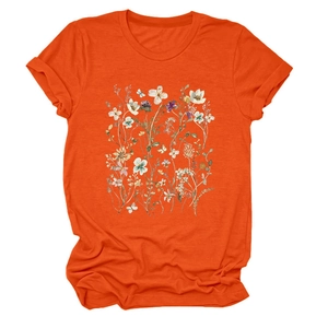 Detail of floral print on bright orange round neck T-shirt with folded cuffs and soft fabric