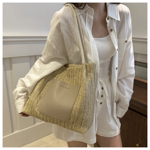 Detail of woven tote bag with leather patch and braided rope straps on white shirt