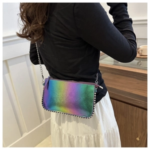 Detail of gradient holographic crossbody bag with silver rivet edges and chain strap