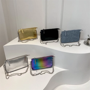 Minimalist rectangular chain crossbody bags in five colors on modern white pedestals
