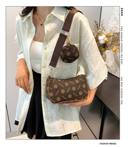 Detail of vintage brown printed crossbody bag with a round mini coin purse attachment
