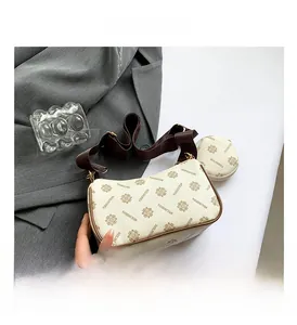 Detail of white floral crescent bag with brown wide strap and small round coin purse