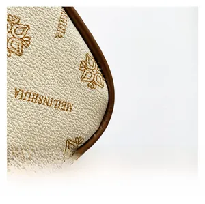 Close-up of beige lychee texture leather handbag with brown monogram floral pattern