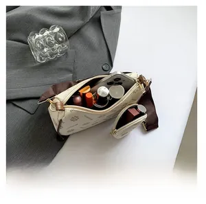 Spacious interior of retro monogram crossbody bag with wide strap for essentials