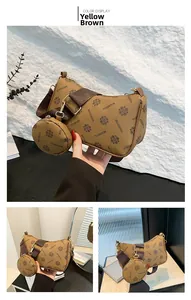 Detail of yellow-brown hobo bag and small coin purse with floral pattern and wide strap