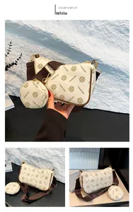 Detail of white PU shoulder bag with vintage print and detachable brown strap