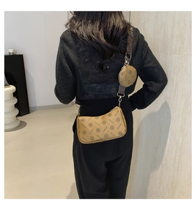 Detailed view of khaki monogram crossbody bag with wide strap and mini round coin purse