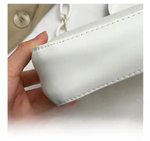 Detailed close-up showing precision stitching and crocodile embossed leather texture