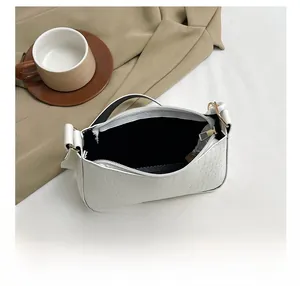 Top view of white crocodile pattern bag showing interior space and zipper detail