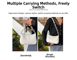 Detail of white crocodile pattern handbag with leather strap and oval link chain