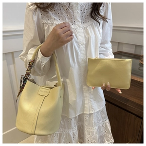 Detail of yellow lychee texture bucket bag with printed silk scarf and inner pouch