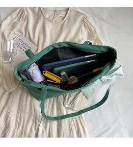 Interior view showing the large capacity of a green tote bag with various accessories