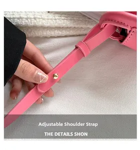 Detailed close-up of pink leather adjustable shoulder strap with gold-tone metal studs