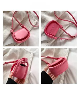 Detail view of pink mini saddle bag with matte finish and fine leather strap