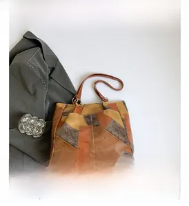 Detail view of contrast color faux leather tote bag with elegant vintage texture