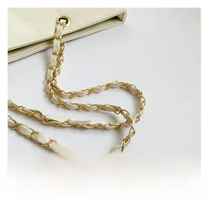 Detail showing elegant gold chain intertwined with cream white leather shoulder strap