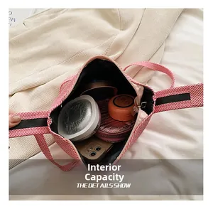 Macro view of checkered handbag interior showing large capacity for phone and cosmetics