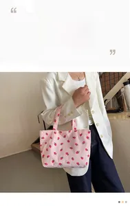 Pink corduroy tote bag featuring strawberry embroidery shown with a white blazer outfit
