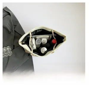 Detail view of large capacity cream tote bag showing spacious interior with golden chain strap